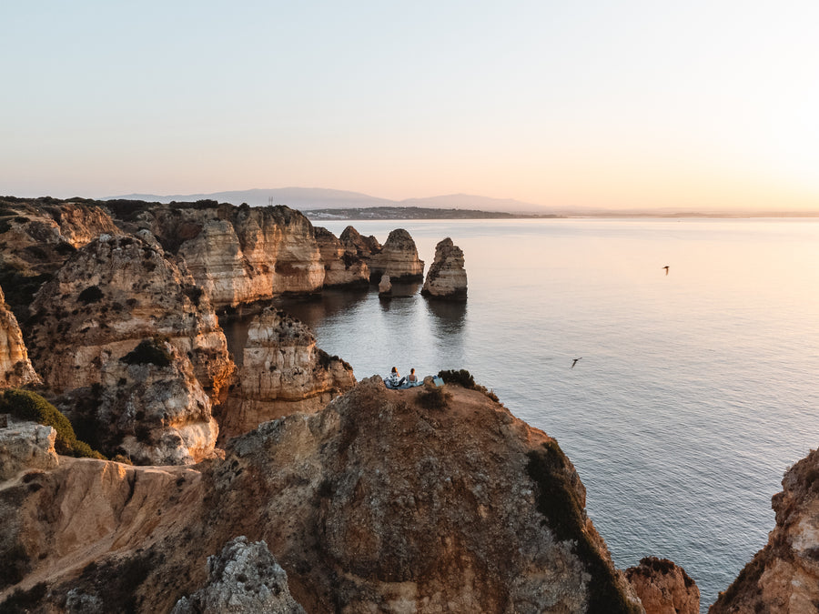 Golden sandstone cliffs and sea stacks on the Algarve coast in soft evening light