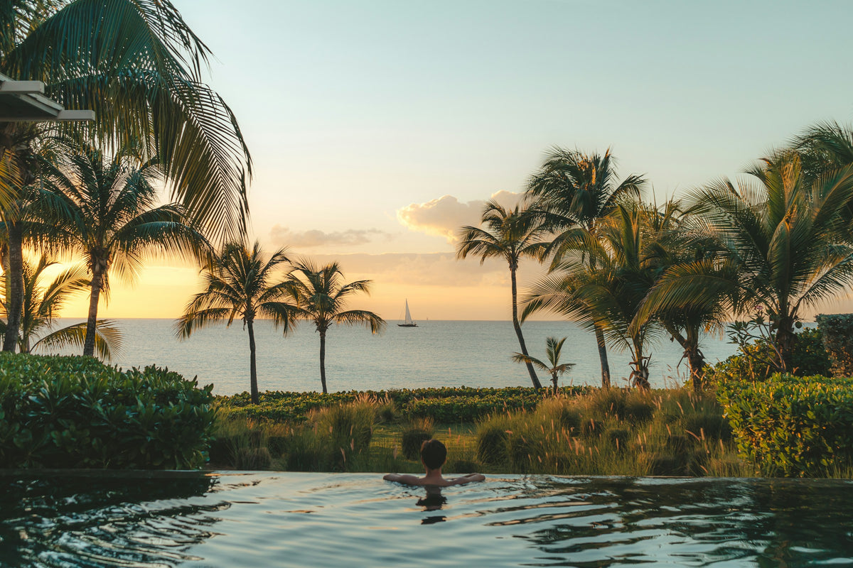 Palm trees and pool at sunset, Anguilla