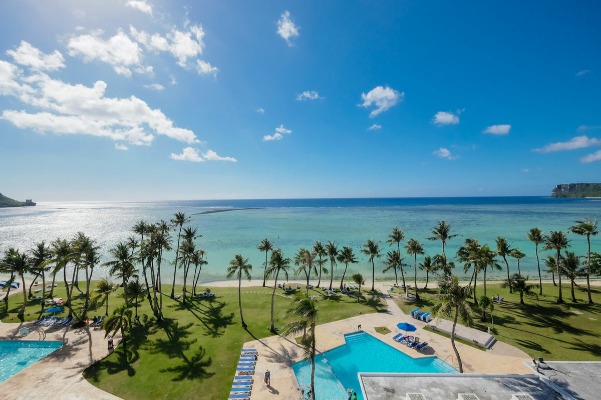 Palm-lined beach and pool, Guam