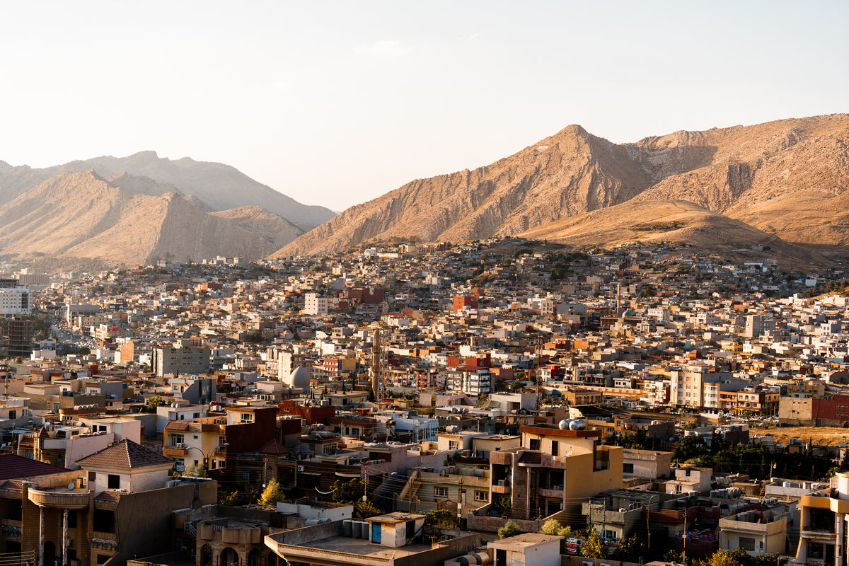 City below rocky mountains, Iraq
