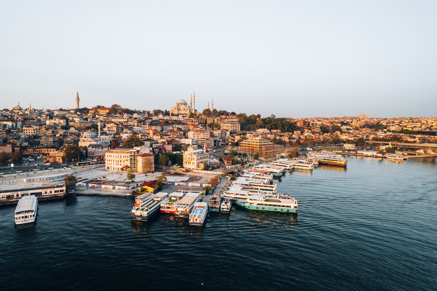 Ferry piers at Eminönü on the Golden Horn, with Süleymaniye Mosque on the hill behind, in golden evening light