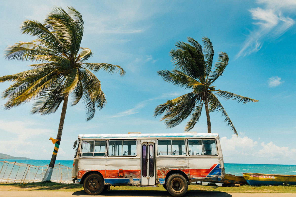 Palm trees and a vintage bus on the beach, Jamaica