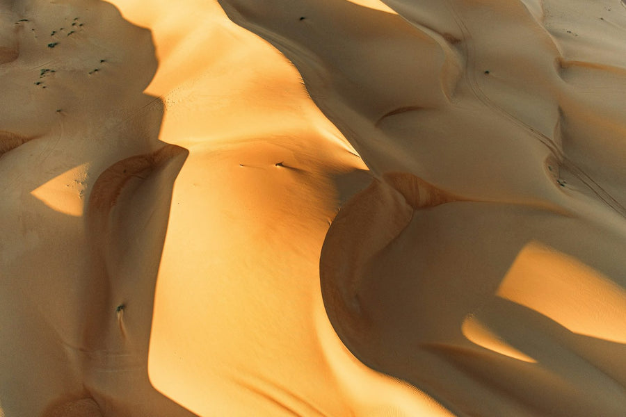 Wind-shaped orange sand dunes of the Wahiba Sands seen from above, Oman