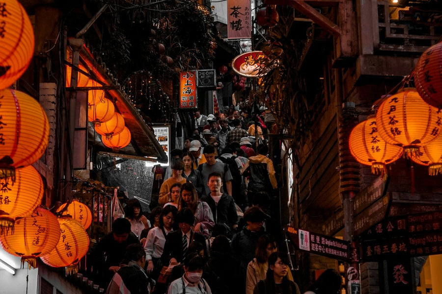 Red lanterns and visitors in a narrow old street in Jiufen at night, Taiwan